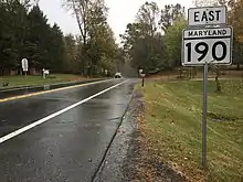 road with trees and vehicle