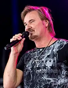 Nik P. performing in 2016