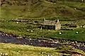 An aerial ropeslide spanning the river, approximately halfway along its course, provides a resident easy access to their cottage (2000)