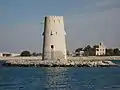 Al-Maqta' Tower (Arabic: بُرْج ٱلْمَقْطَع, romanized: Burj Al-Maqṭaʿ; front) and Al-Maqta' Fort (Arabic: حُصْن ٱلْمَقْطَع, romanized: Ḥuṣn Al-Maqṭaʿ; back), just outside the island of Abu Dhabi