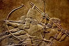Image 157th-century BC relief depicting Ashurbanipal (r. 669–631 BC) and three royal attendants in a chariot. Ashurbanipal was the king of the Neo-Assyrian Empire which was the largest empire in history up to that point. (from History of Iraq)