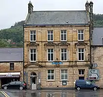 Barclays Bank, the building stands at the junction of Bridge Street and Town Foot (B6341).