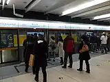 Passengers boarding a westbound line 6 train