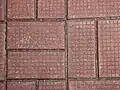 Bricks are glued together. This helps prevent people from using the bricks as weapons.
