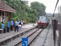 Train driver dropping a key token for the northern section between Woodlands and Bukit Timah.