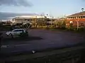A car and bicycle park and some office buildings.