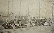 Actors and soldiers with a mock-up train, 1899