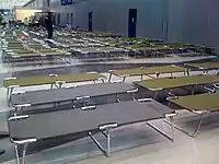 For passengers stranded overnight, secure area at O'Hare International Airport with dimmed lights, cots, pillows, blankets, and toiletries (2008)
