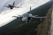 Czech Saab JAS 39 Gripen fighters over the Curonian Spit while participating in the Baltic Air Policing mission in 2012.