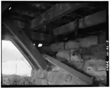 Detail of double Burr Arch ring bearing on stone abutment, truss and lower chord