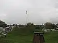 Doubleday Hill Monument shown with Flag and Cannon