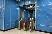 Stairs from the middle platform to the concourse, with separate turnstiles for passengers to exit the station