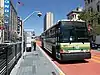 A bus stop with bus in the median of an urban arterial