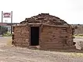 Gas station sign behind a building on Fort Courage