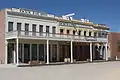 Photograph of the Big Four House in Old Sacramento, with signs "Central Pacific Rail Road Company", "Huntington & Hopkins", and "Hardware".