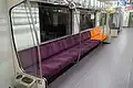 Partial-width longitudinal seat with priority seating at the end (orange)