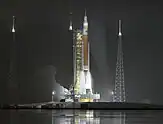  A 365-foot-tall orange and white rocket lifting off of Pad 39B at the Kennedy Space Center, at night