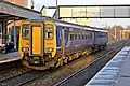 A Northern Rail Class 156 departs from the station.