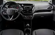  Dashboard of left-hand-drive car with rotary climate controls, a manual gearbox, and a handbrake