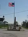 World War I veterans memorial in Pickrelltown (2010 photo).  The 8&nbsp;ft (2.4&nbsp;m) high granite monument was erected in 1921, and has twice been rebuilt after vehicles crashed into it.