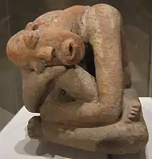 Terracotta seated figure; 13th century; earthenware; 29.9&nbsp;cm (113⁄4&nbsp;in.) high; Metropolitan Museum of Art (New York City, USA) The raised marks and indentations on the back of this hunched Djenné figure may represent disease or, more likely, sacrification patterns. The facial expression and pose could depict an individual in mouring or in pain