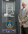 Sherman Wetmore poses next to a collection of Project AZORIAN artifacts on display.