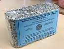Shredded and briquetted US dollar notes from the Federal Reserve Bank of New York (approx.&nbsp;1000 pieces, 1&nbsp;kg)