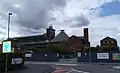 North-east side of the mill in June 2013 showing the scaffolding with white plastic sheeting for the restoration. Taken from the junction of St Michael's Street and Sultan Road.