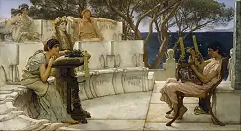 A man plays the lyre in front of an audience of five women, in a Greek-style theatre. The names of women associated with Sappho are inscribed on the seats.