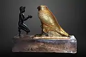 Taharqa offering wine jars to Falcon-god Hemen; 690–664 BC; bronze, greywacke, gold and wood; length: 26 cm, height: 19.7 cm, width: 10.3 cm; Louvre