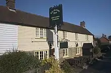 A building outside which stands a pub sign with the wording "The Gallipot Inn 16th century freehouse"