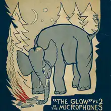 Elephant near a campfire in a forest
