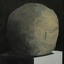 a painting of a stone with a matchstick sticking out of it sitting on a minimalist pedestal