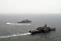 A rigid-hull inflatable boat from the LCS USS&nbsp;Freedom takes a visit, board, search and seizure team to the Malaysian frigate KD Jebat during a compliant boarding exercise.