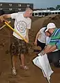 Manual filling of sandbags.