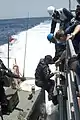 Sailors of USS Gettysburg assist crew members of RSS Persistence in the Gulf of Aden on 17 May 2009.