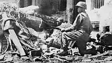 Viet Minh soldier Nguyen Van Thieng holding a lunge mine at Hàng Đậu Street in December 1946.