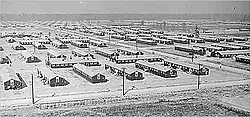 fifty plain long wooden buildings interlaced with roads