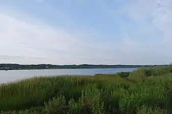 Winnapaug Pond (also known as Brightman Pond) is a breached saltwater pond in Westerly, Rhode Island, United States, connected to Block Island Sound by the Weekapaug Breachway, which was constructed during the mid-1950s. The 2.5-mile (4.0 km) long lake is separated from the Atlantic by a large sandbar.