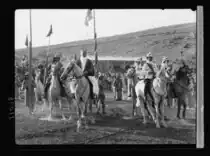 King Talal (mounted, right of center) and King Saud of Saudi Arabia (mounted, left of center)